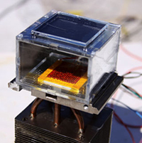 The proof-of-concept water harvester consists of an MOF layer under a glass plate, a condenser (the yellow square), and a heat sink extending below.